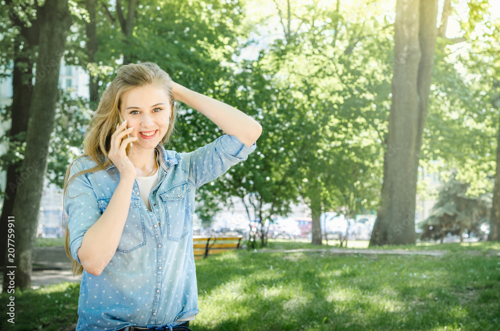 Smiling bussines casual woman holding call smartphone mobile cell with long hair in green nature park sunny day background Smiling bussines casual woman holding call smartphone mobile cell with long hair in green nature park sunny day background