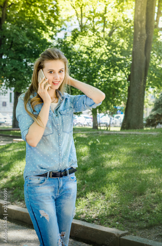 Smiling bussines casual woman holding call smartphone mobile cell with long hair in green nature park sunny day background Smiling bussines casual woman holding call smartphone mobile cell with long hair in green nature park sunny day background