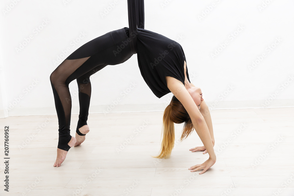 Young woman playing yoga fly