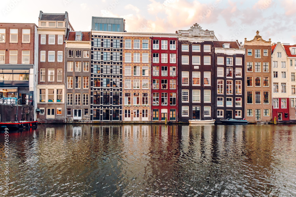 Amsterdam's Domarque Canal with traditional houses at sunrise