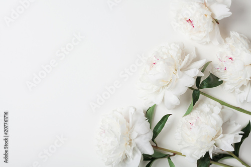 Fototapeta Naklejka Na Ścianę i Meble -  Beautiful white peony flowers bouquet on pastel table top. Flat lay style.