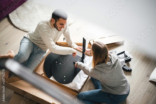 Couple assembling flat pack furniture photo