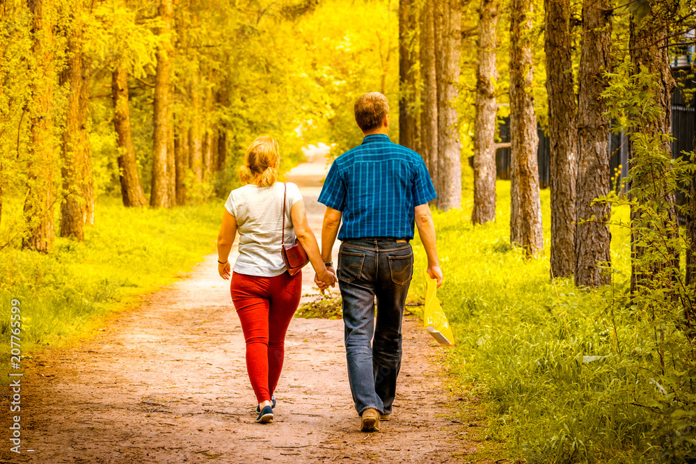 Fototapeta premium A pair of lovers are on the forest road
