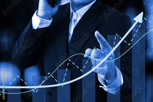 Chart direction up trend and volume with background  business man point finger. photo