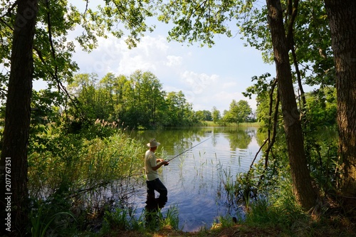 Fisherman in the lake during sunny day
