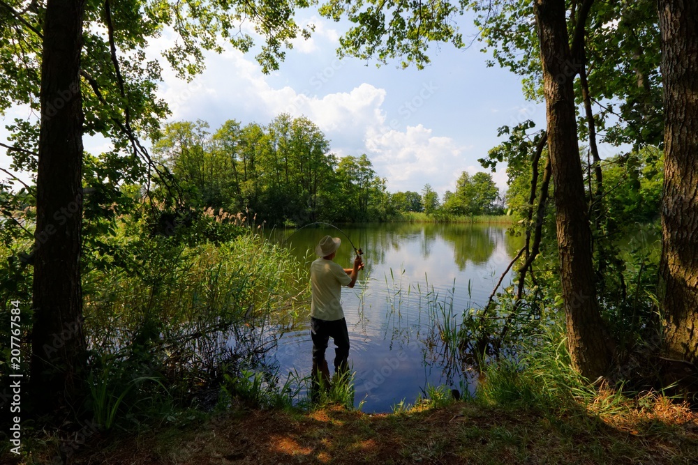 Fisherman in the lake during sunny day