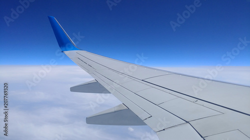 View of a gray airplane wing through the aircraft window