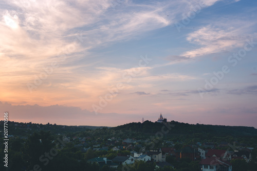 Sunset blue magenta violet yellow sky in Poltava, Ukraine rural countryside landcape with church; siluette; city town scenery