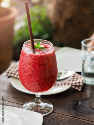 Strawberry smoothie in the wine glass with warm light