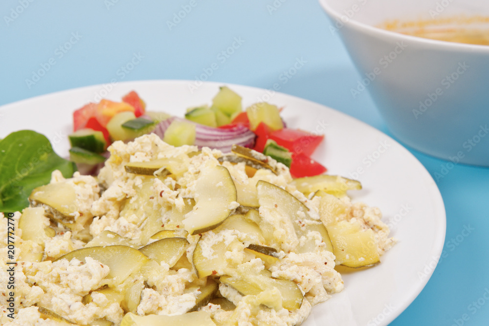 Baked zucchini vegetable salad on a white Baked zucchini vegetable salad on a white