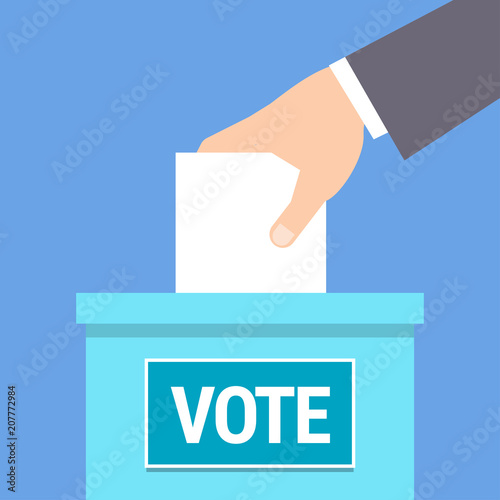 Hand putting paper in ballot box.