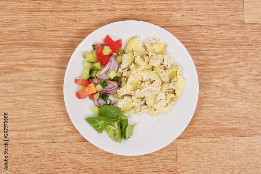Baked zucchini vegetable salad on a white