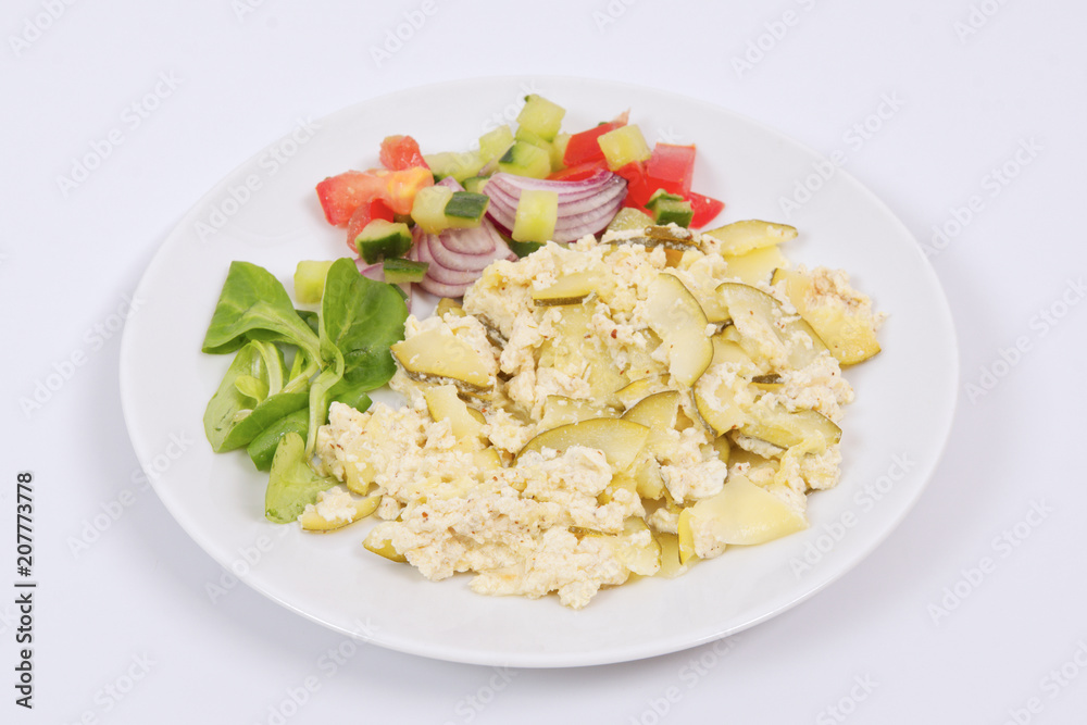 Baked zucchini vegetable salad on a white