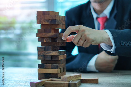 Businessman Building Up Tower, Challenge In Business Concept photo