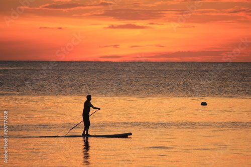 stand up paddle on the beach sunset