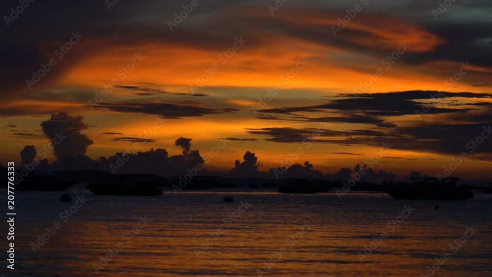 BEAUTIFUL GOLDEN CLOUD SUNSET WITH FISHERMAN BOAT ON THE OCEAN IN PATAYA THAILAND