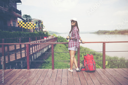 backpack woman beside river © ittipol