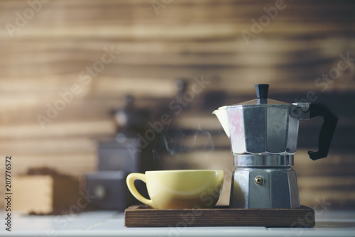  cup of coffee with metal coffee percolator on wooden background, photo