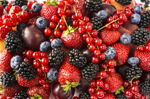 Fototapeta Naklejka Na Ścianę i Meble -  Ripe blackberries, blackberries, strawberries, red currants, peaches and plums. Mix berries and fruits. Top view. 