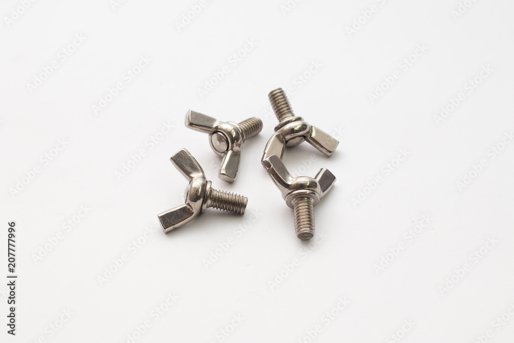Hardware parts stainless steel winged screw bolts on white background. Hardware parts stainless steel winged screw bolts on white background.