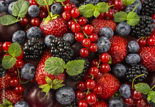 Ripe blackberries, blackberries, strawberries, red currants, peaches and plums. Mix berries and fruits. Top view. 