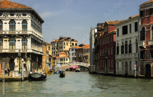 Venice canal street with gondola and tourists. Italy