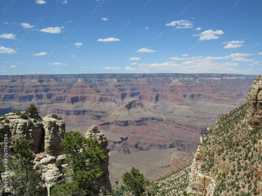 Grand Canyon views as seen from the South Rim Trail on a sunny day with blue sky and some clouds 
