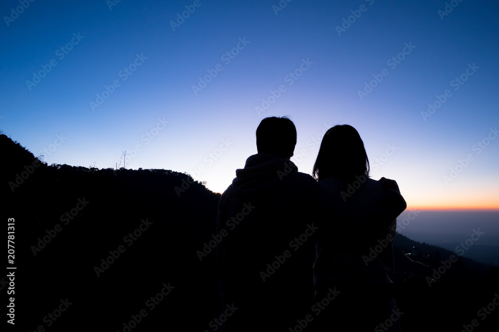 Silhouette image of Couples watching the sunrise.