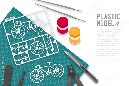 Plastic model with tool kit on cutting mat, bicycle concept design illustration isolated on white background with copy space