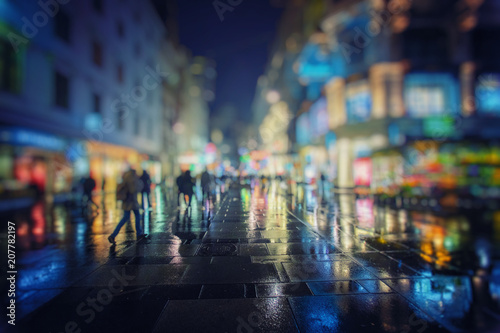 crow of people walking on rainy night in the city 