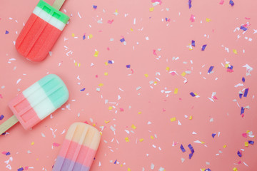Table top view aerial image of food for summer holiday background concept.Flat lay ice cream pop stick on modern rustic pink paper wallpaper.Copy space for creative design for add text and content.