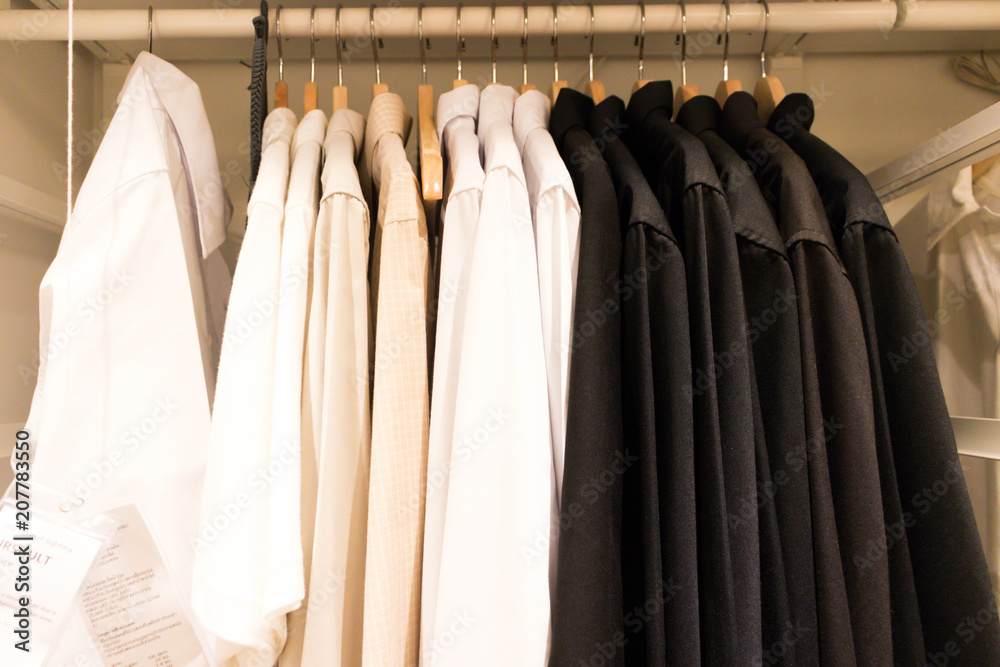 Obraz premium Several shirts are hanging in the wardrobe