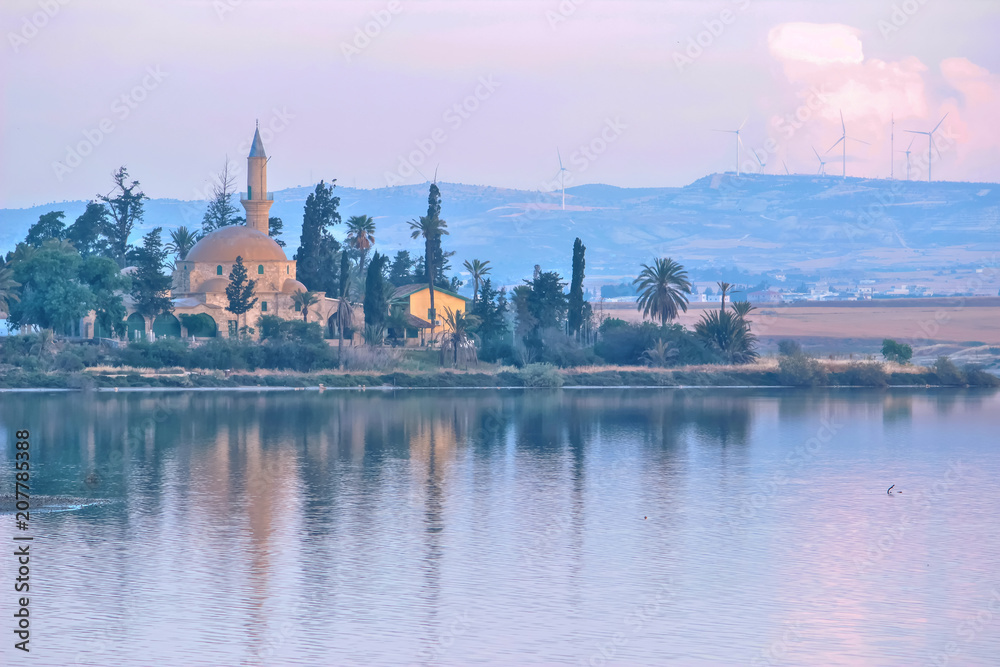 Architecture of Hala Sultan Tekke with cloudy sky and reflections
