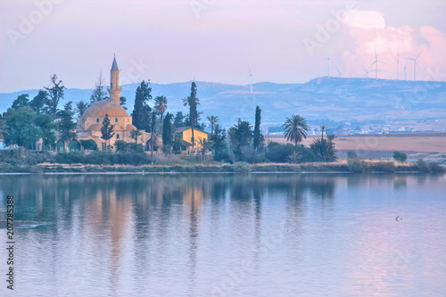 Architecture of Hala Sultan Tekke with cloudy sky and reflections