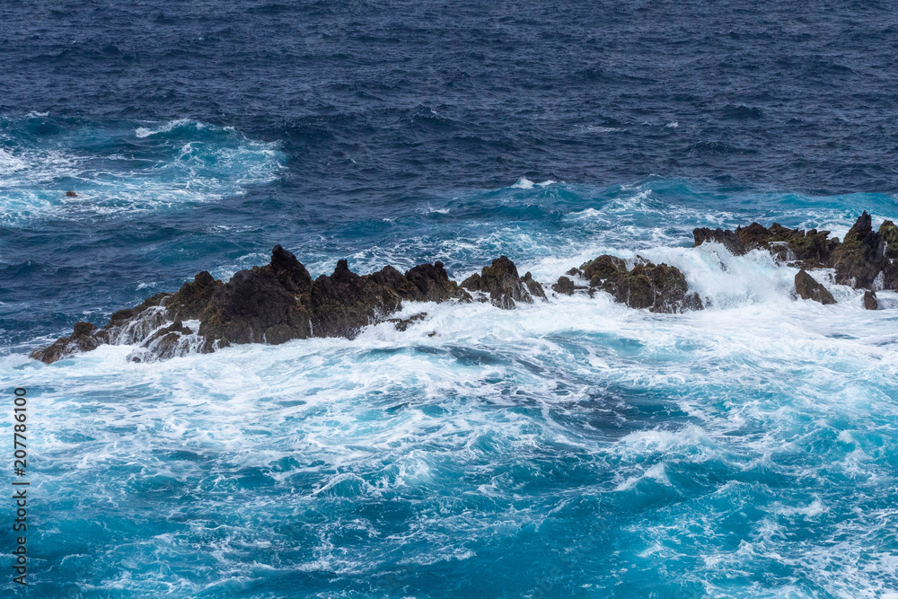 Waves crashing against a rocky coast in Atlantic ocean Waves crashing against a rocky coast in Atlantic ocean