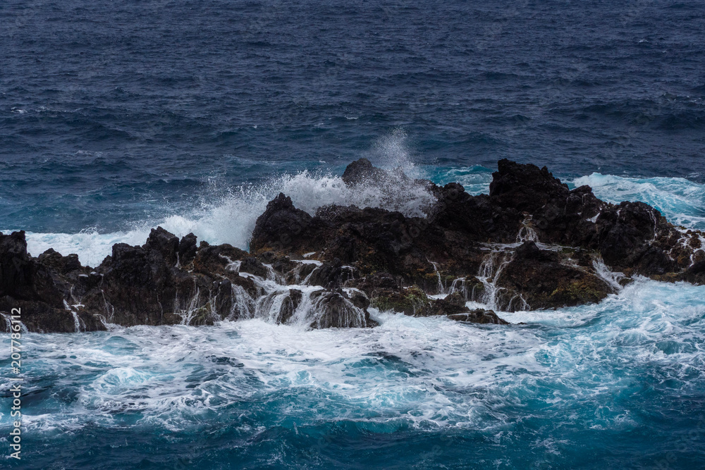 Waves crashing against a rocky coast in Atlantic ocean Waves crashing against a rocky coast in Atlantic ocean