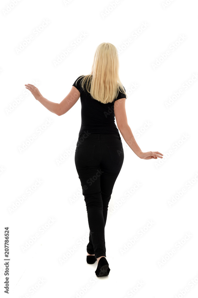 full length portrait of blonde girl wearing black clothing, isolated on white background. full length portrait of blonde girl wearing black clothing, isolated on white background.