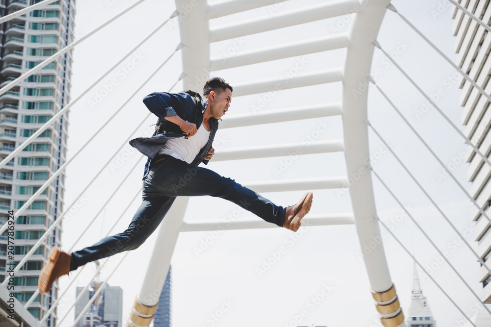 Handsome Asian Guy Is Running Fast And Jumping Highly Attractive Young Man Gets Hurry Because He