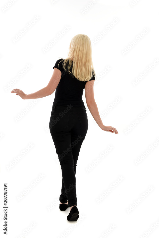 full length portrait of blonde girl wearing black clothing, isolated on white background. full length portrait of blonde girl wearing black clothing, isolated on white background.