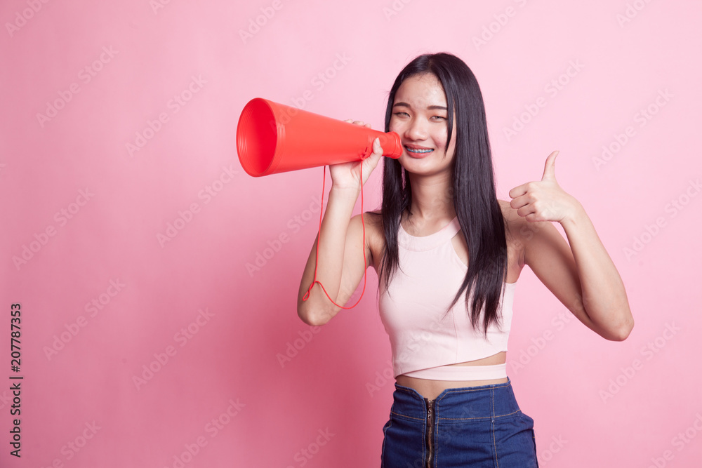 Beautiful young Asian woman show thumbs up announce with megaphone. Beautiful young Asian woman show thumbs up announce with megaphone.