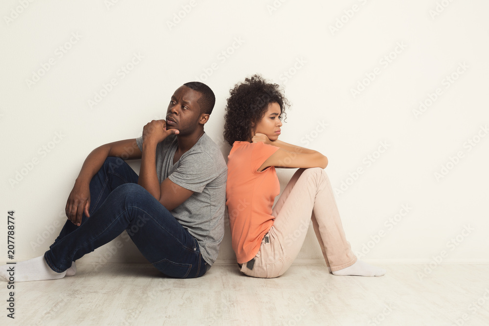 Black couple sitting on floor at new apartment Black couple sitting on floor at new apartment