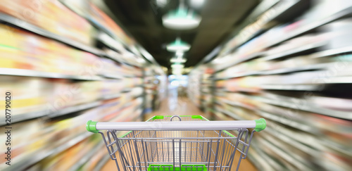 supermarket aisle and product shelves abstract motion blur with shopping cart