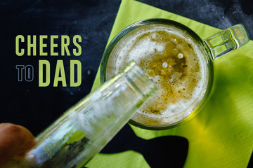 Father's day graphic with cheers to dad text and beer pouring into glass.