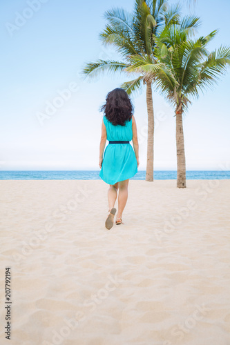 Young beautiful asian woman is walking on the beach