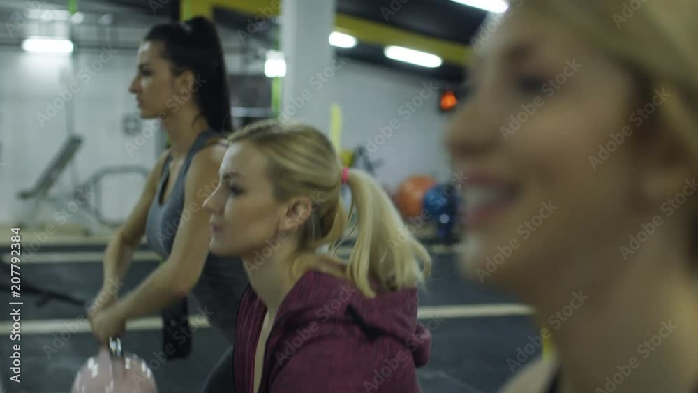 Strong muscular athletes working out training with kettlebells. Strong muscular athletes working out training with kettlebells.