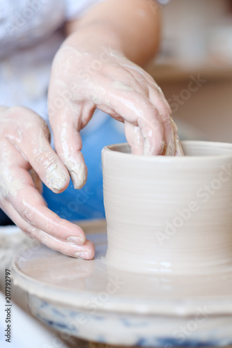 pottery handcraft hobby. hands forming and shaping on potter wheel