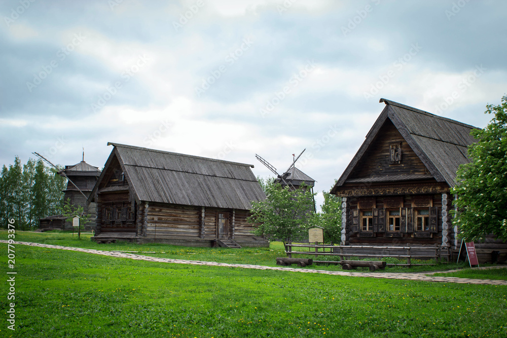 Fototapeta premium Old log houses in the village. Museum of wooden architecture in Suzdal, Russia