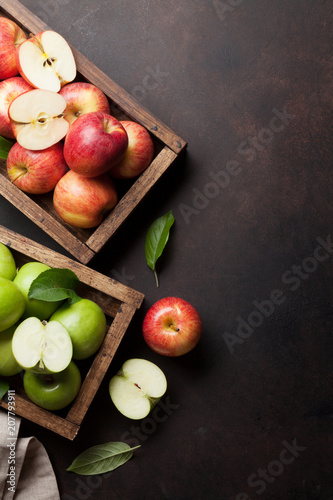 Green and red apples in wooden box