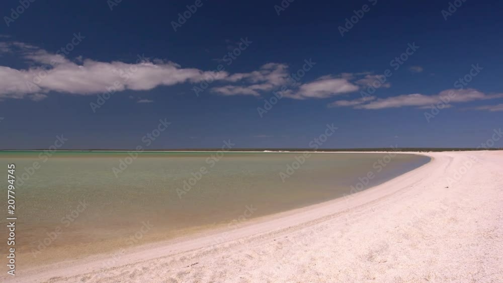 A wide shot of the ocean and a white sand. A wide shot of the ocean and a white sand.