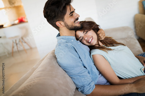 Pretty young girl lying on lap of her boyfriend